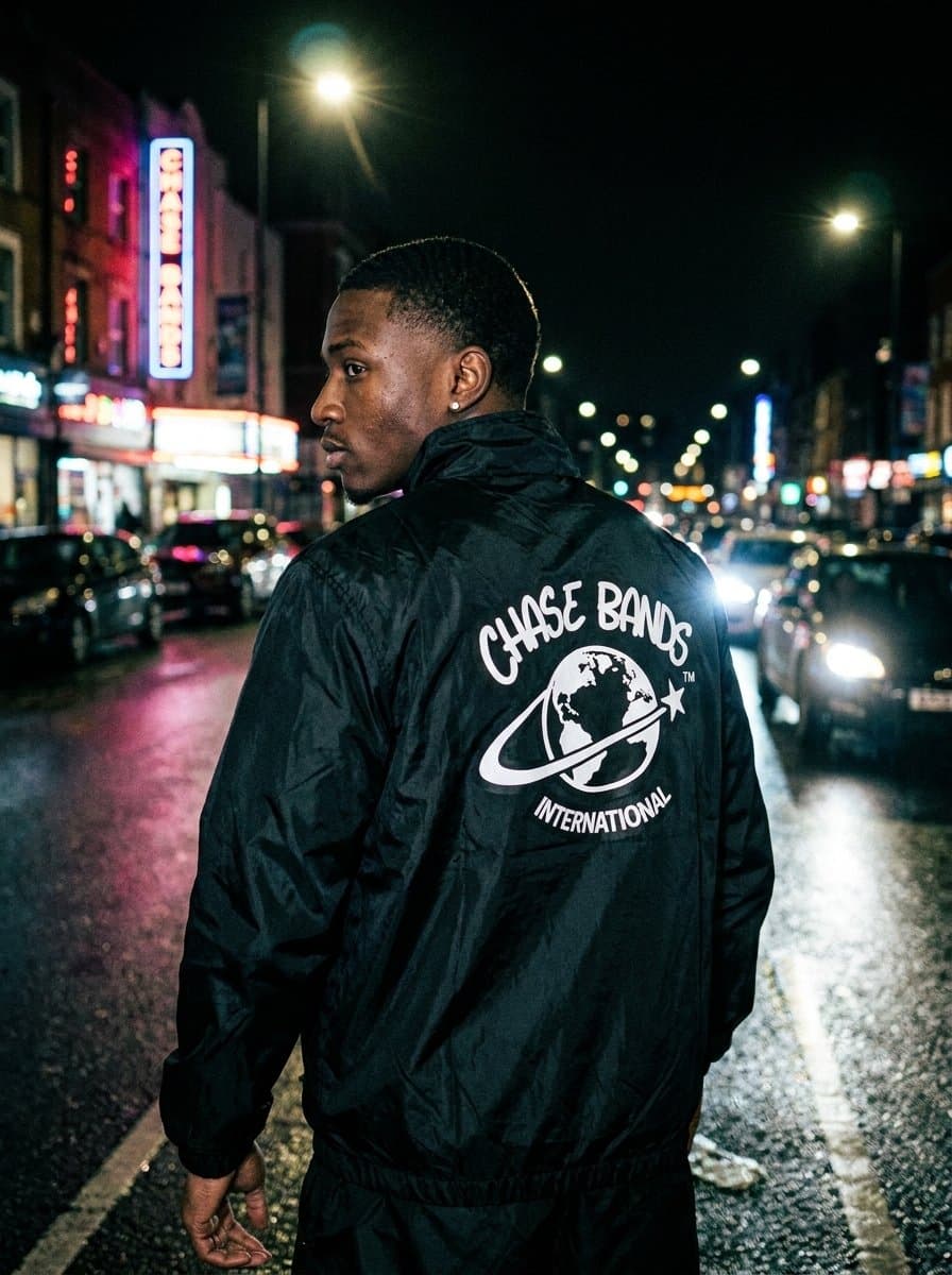 Chase Bands International windbreaker, back print with globe logo, street at night